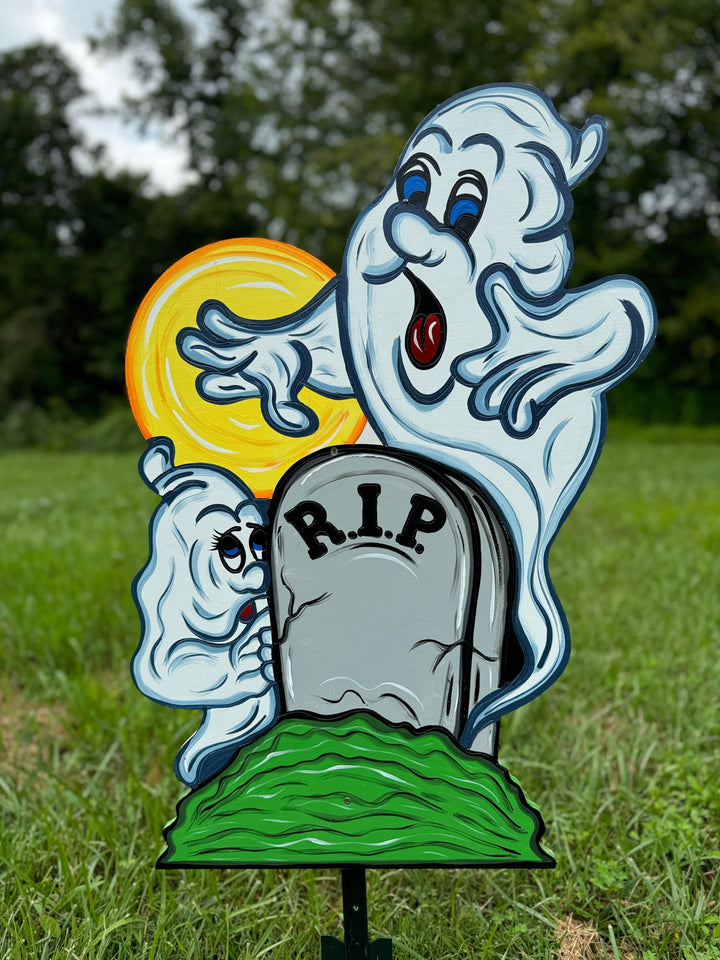 Two Halloween Ghosts Peeking over RIP Tombstone