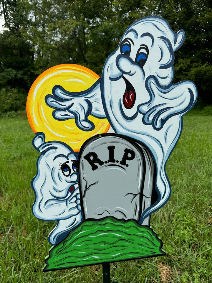 Two Halloween Ghosts Peeking over RIP Tombstone