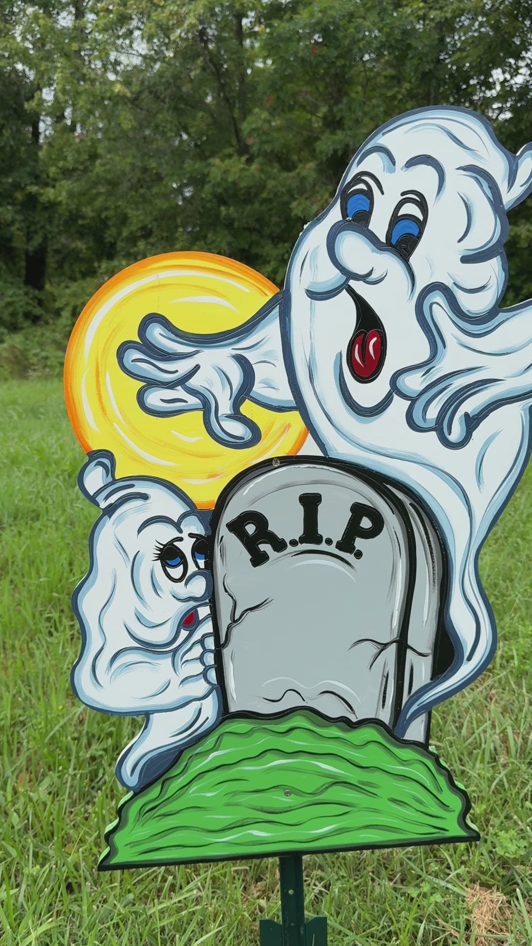 Two Halloween Ghosts Peeking over RIP Tombstone