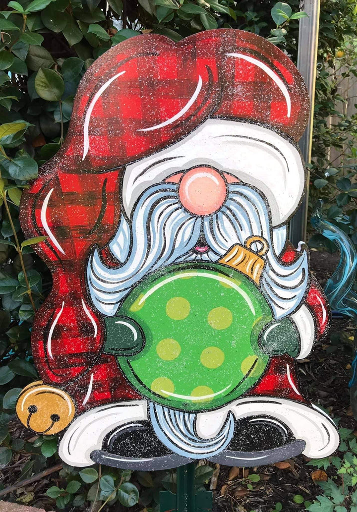 glitter santa gnome holding ornement with checkard santa hat painted yard art design