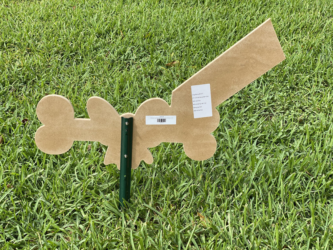 back of Christmas dog bone with bow and tag yard art