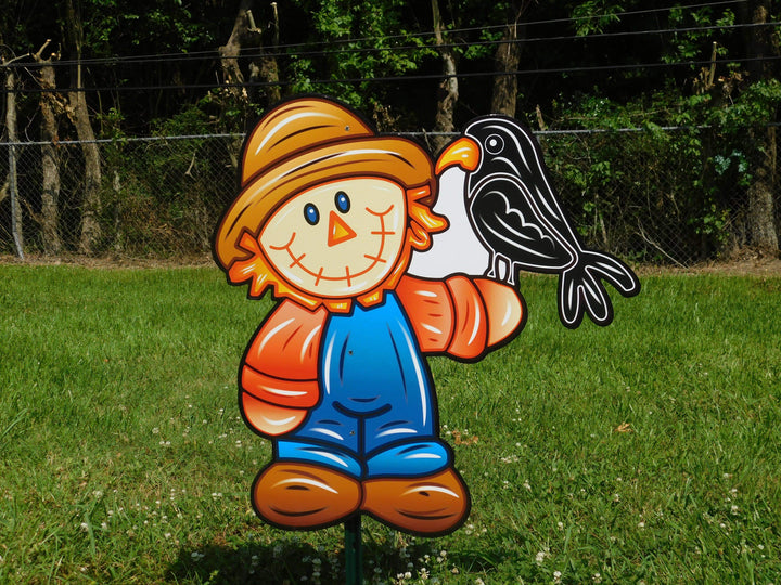 cute scarecrow with crow on arm painted yard art design