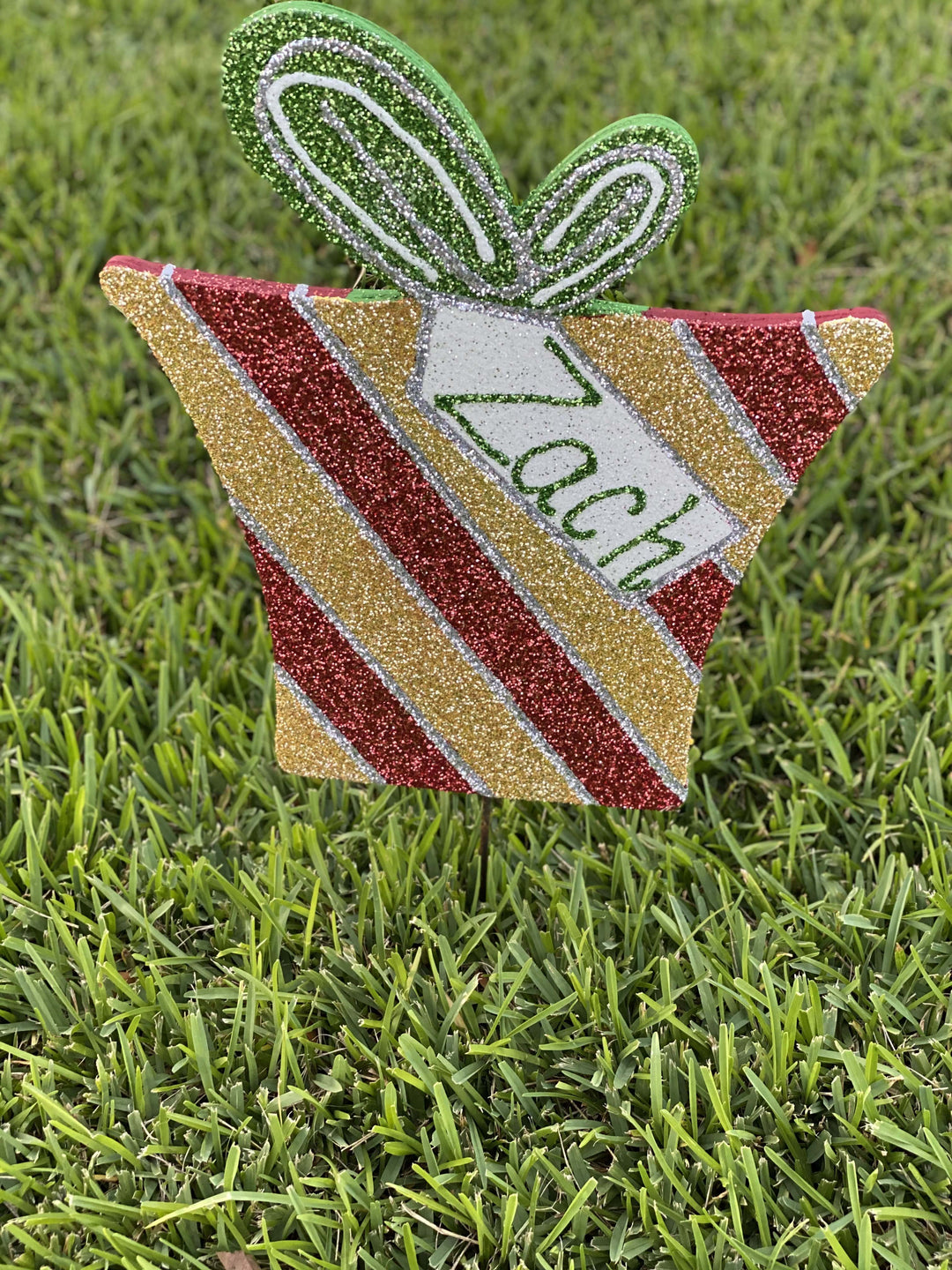 striped glitter Christmas present with tag painted yard art design